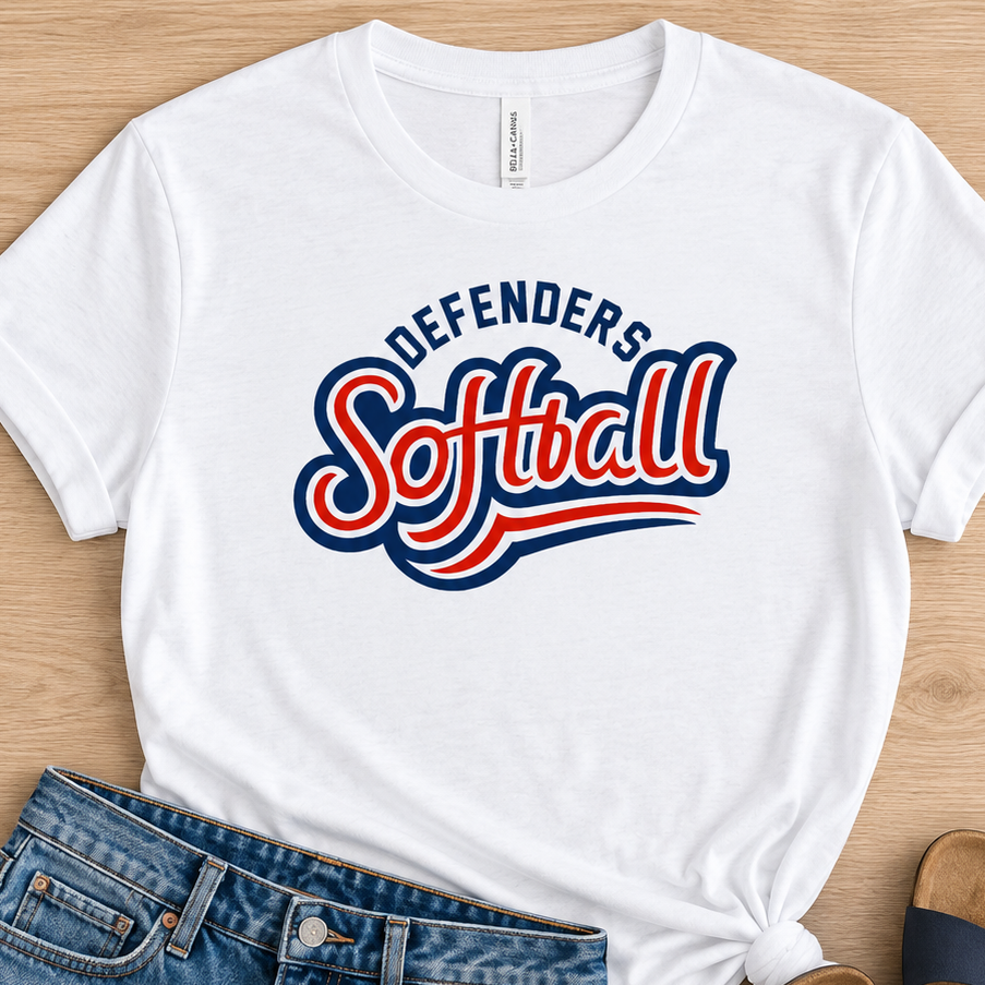 A white graphic t-shirt with 'Defenders Softball' printed in red and blue, styled in a flat lay with distressed denim shorts and navy blue slide sandals on a light wood background.
