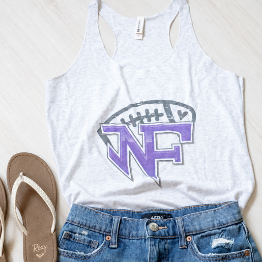 A styled flat-lay outfit featuring a light gray racerback tank top with a purple and gray 'WF' football graphic, paired with distressed blue denim shorts and a pair of brown flip-flops on a light wood background.