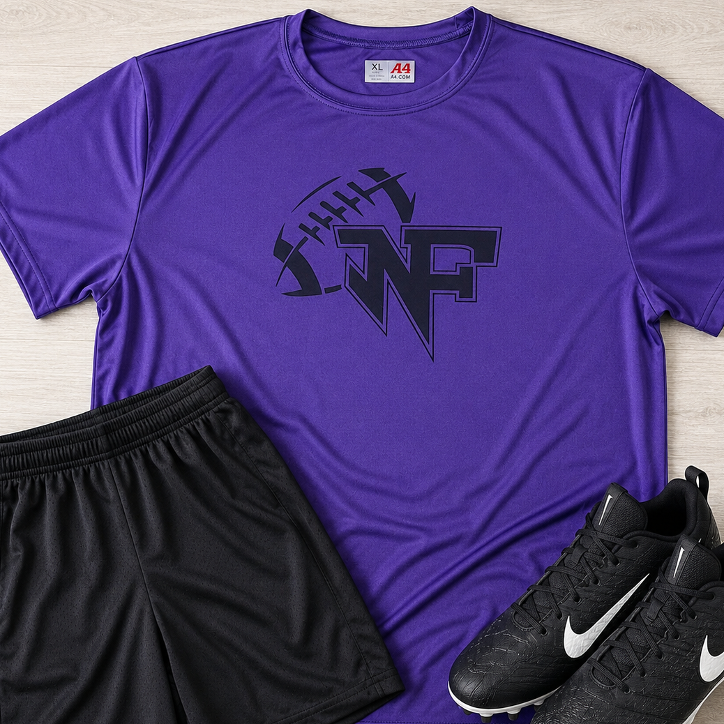 A purple athletic t-shirt with a black football graphic and 'WF' logo, laid flat on a light wood background alongside black athletic shorts and black Nike cleats.
