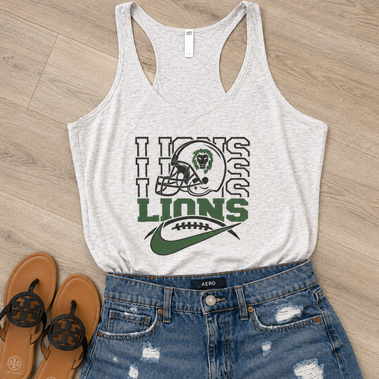 A heather light gray racerback tank top with a green and black 'Lions' football graphic, styled in a flat lay with distressed blue denim shorts and brown flip-flops on a light wood floor.
