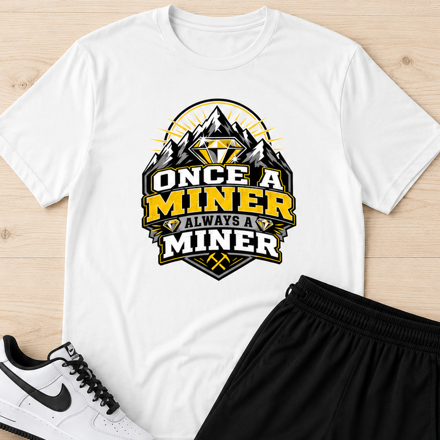 A flat-lay outfit set on a light wood background featuring a white graphic t-shirt with a 'Once a Miner Always a Miner' mountain design, black athletic shorts, and white Nike Air Force 1 sneakers.
